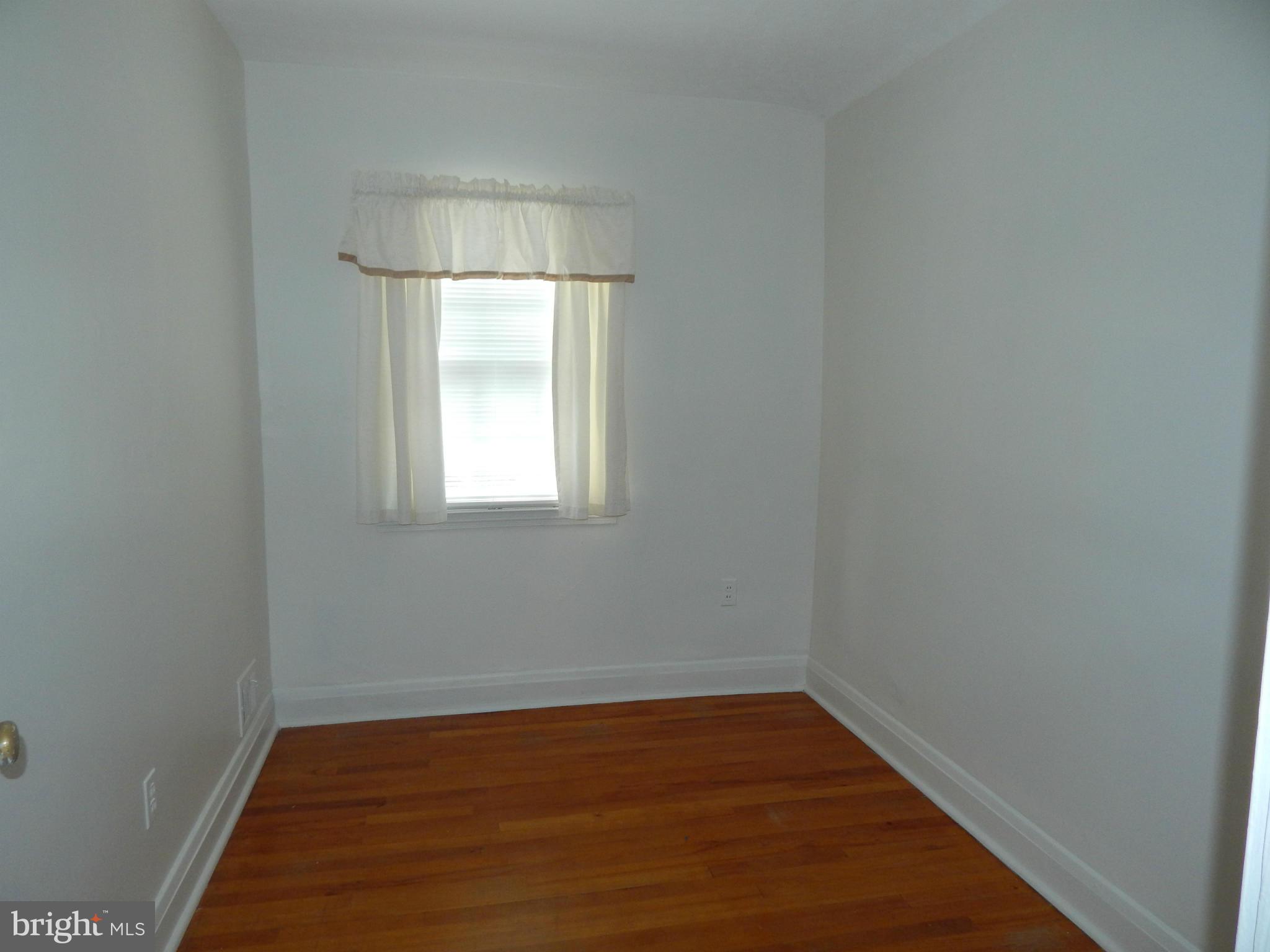 1884 Yakona Road Baltimore, MD 21234 - Photo 12 of 19 a view of an empty room with wooden floor and a window