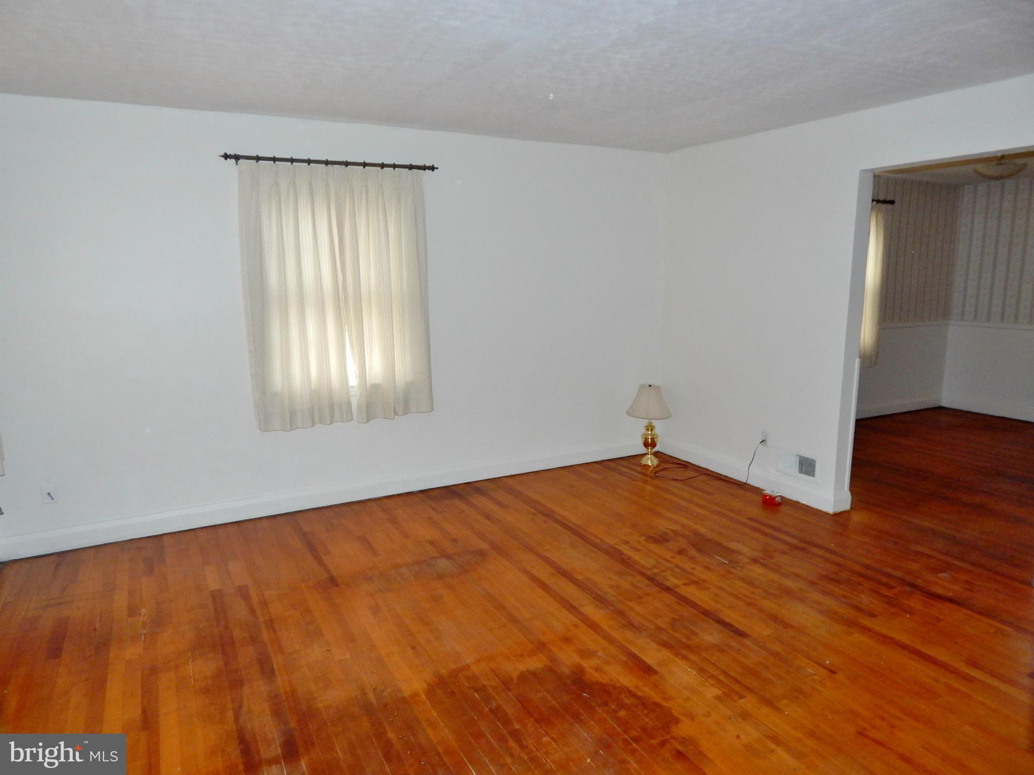 1884 Yakona Road Baltimore, MD 21234 - Photo 4 of 19 a view of an empty room with wooden floor and a window