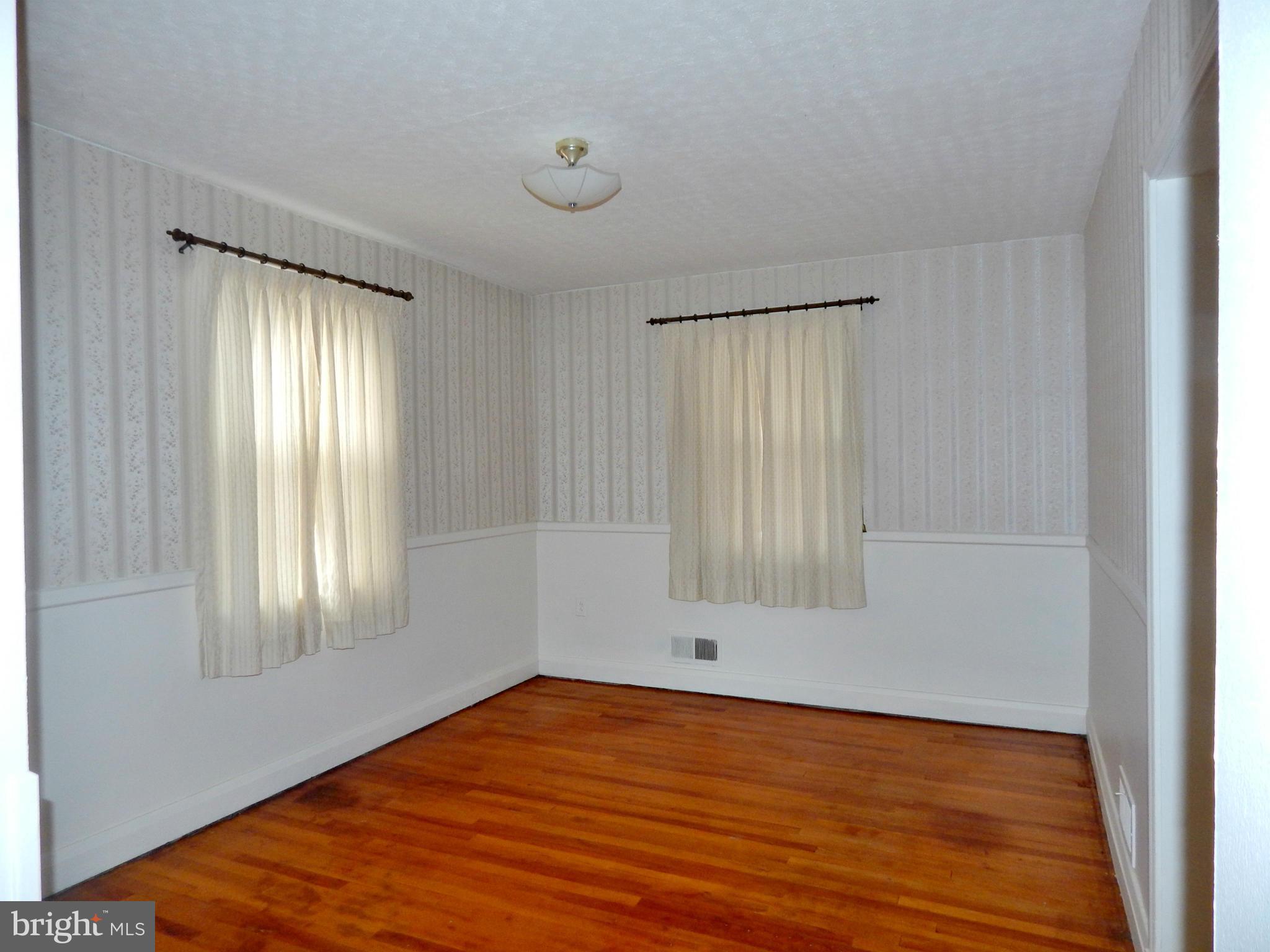 1884 Yakona Road Baltimore, MD 21234 - Photo 6 of 19 a view of empty room with wooden floor and fan