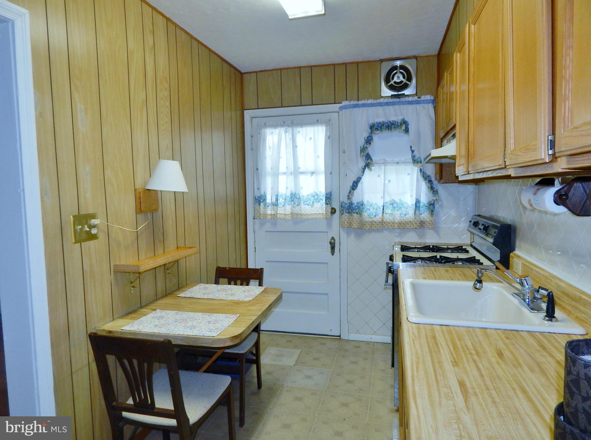 1884 Yakona Road Baltimore, MD 21234 - Photo 7 of 19 a kitchen with a table chairs and a refrigerator