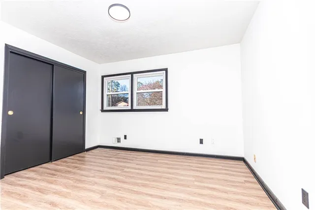 a view of a room with wooden floor