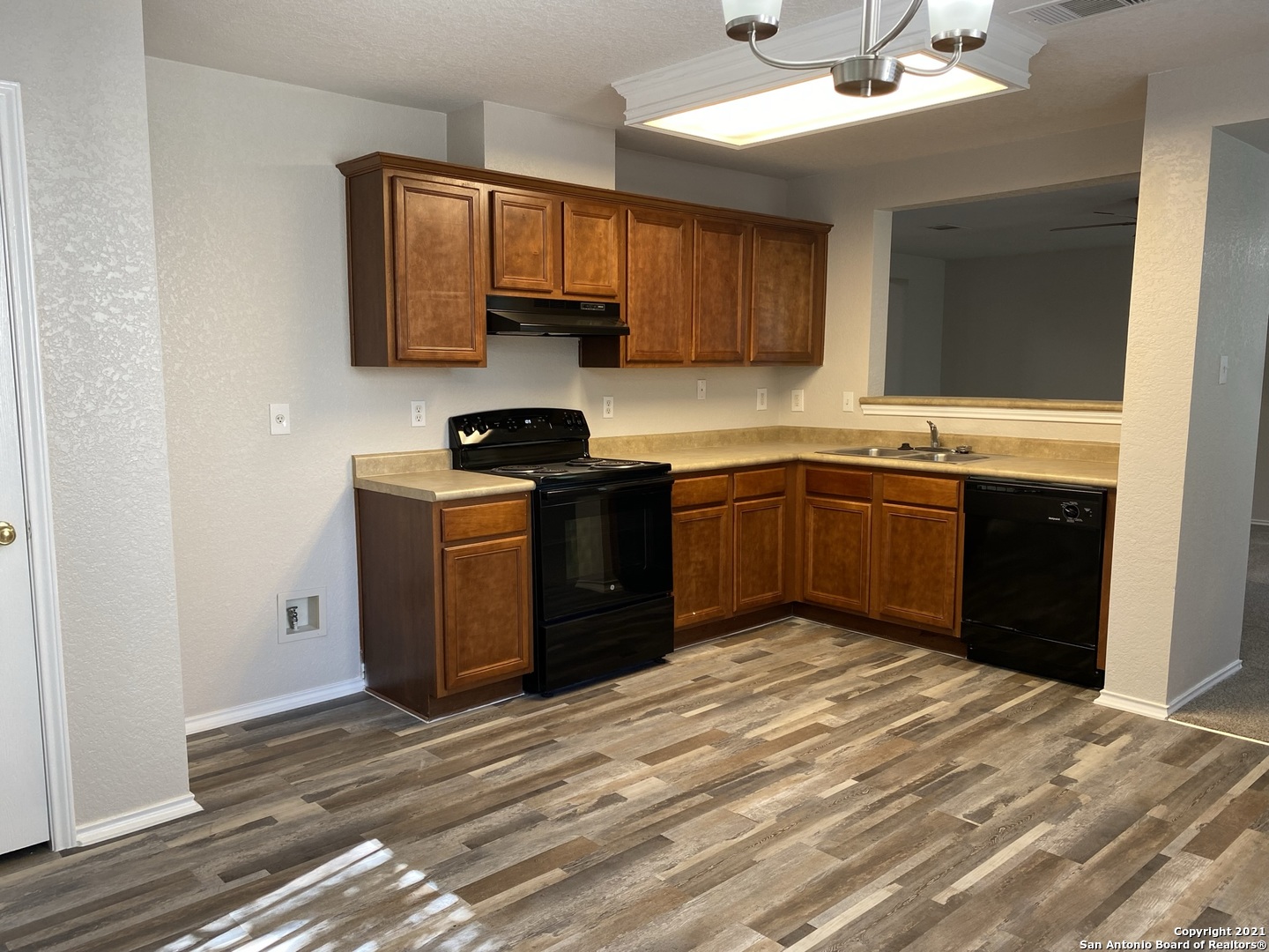 511 Mathis Meadow San Antonio, TX 78251 - Photo 4 of 13 a kitchen with stainless steel appliances granite countertop a sink stove and refrigerator