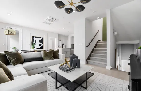 a living room with furniture and wooden floor