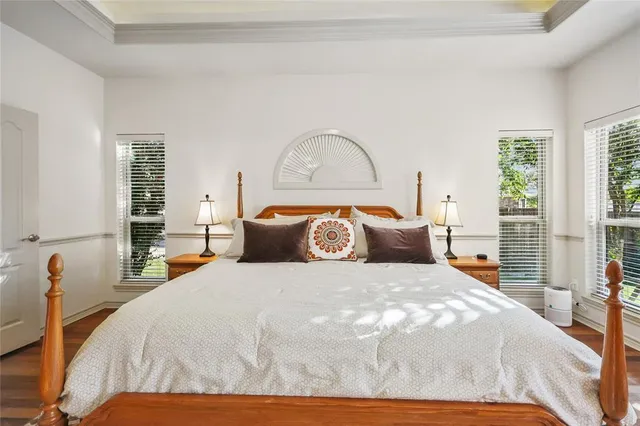 a large bed sitting in a bedroom next to a window