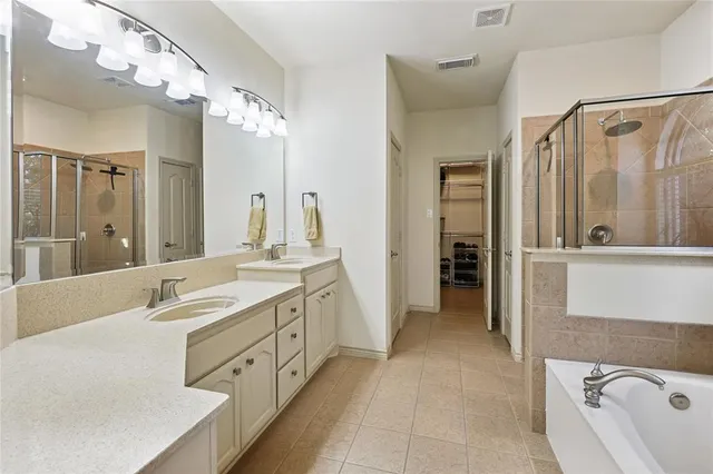 a spacious bathroom with a double vanity sink mirror and double