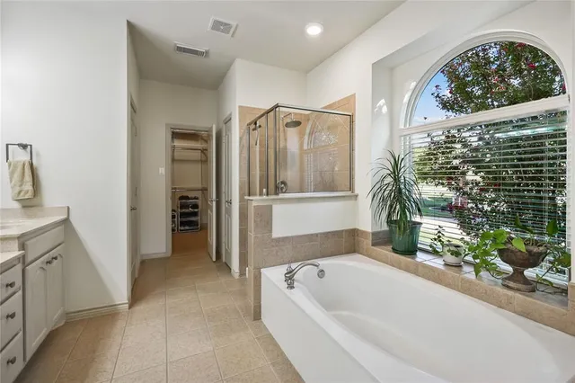 a bathroom with a bathtub and a shower