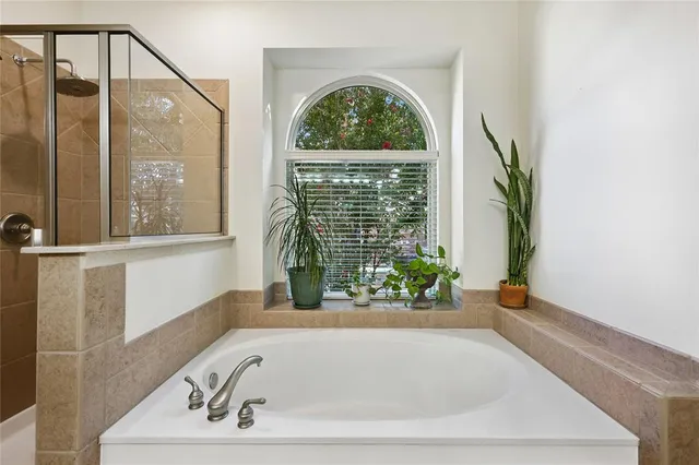 a bathroom with a bathtub and window