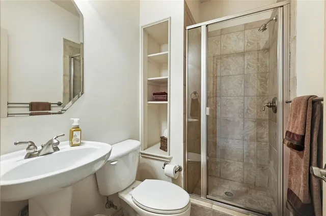 a bathroom with a sink toilet and shower