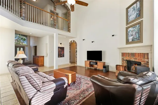 a living room with furniture a fireplace and a flat screen tv