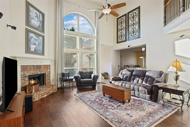a living room with furniture fireplace and wooden floor