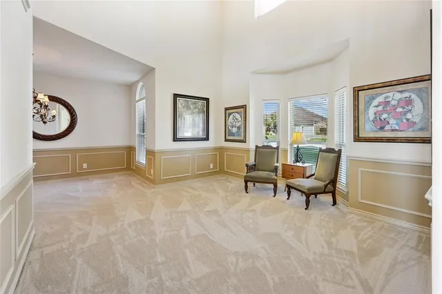 a living room with furniture a clock and a window