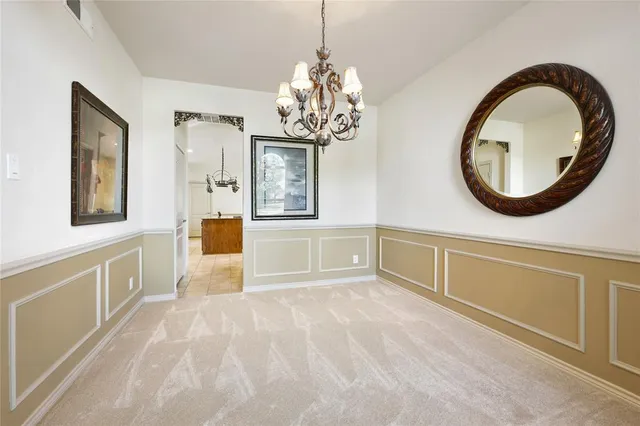 a spacious bathroom with a granite countertop sink a mirror and a bathtub