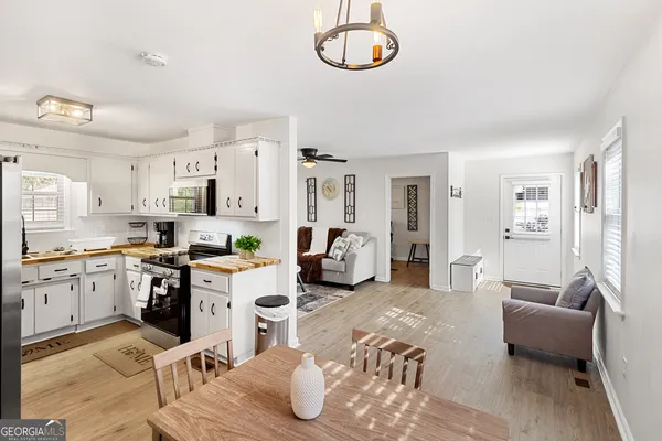 a kitchen with stainless steel appliances granite countertop a refrigerator and stove top oven