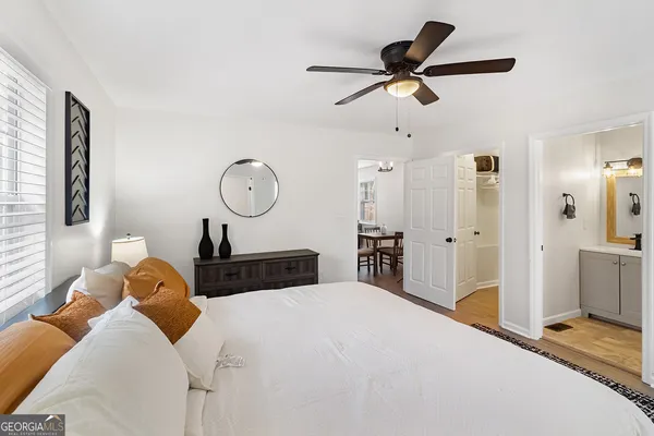 a bedroom with bed and a chandelier