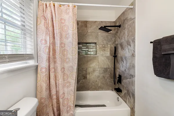 a bathroom with a shower and a toilet
