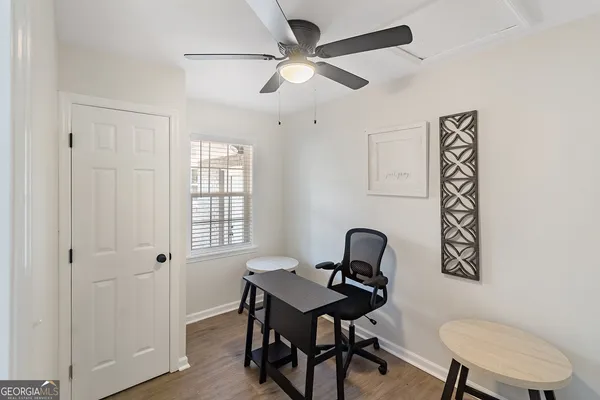 a view of a workspace with furniture and a window
