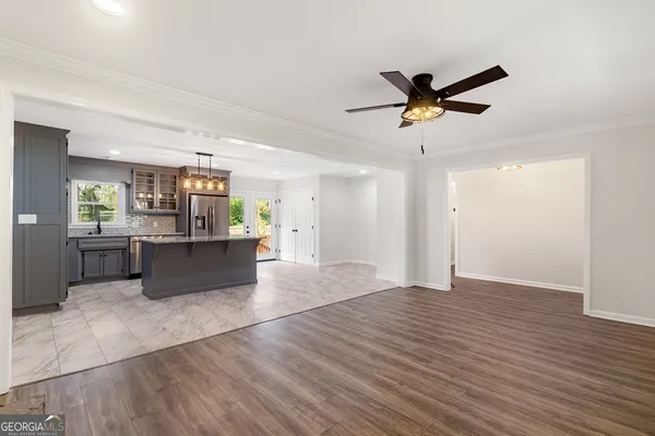 a view of a kitchen with wooden floor and a sink