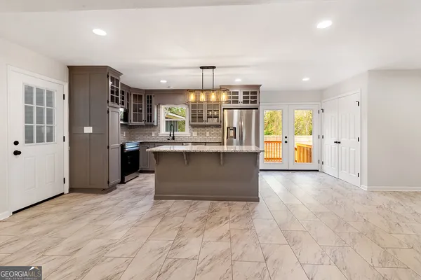 a view of a kitchen with a sink and refrigerator
