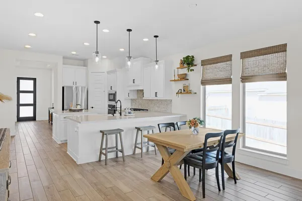 a view of a dining room with furniture window and wooden floor