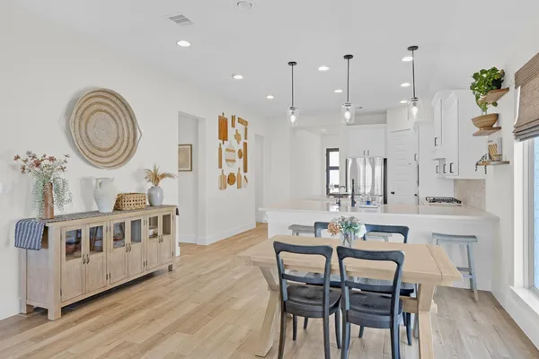 a dining room with furniture and wooden floor