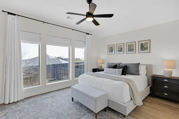 a bedroom with a large bed and a window