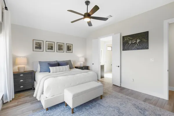 a bedroom with a bed and a night stand