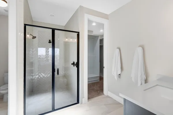 a bathroom with a shower and a sink