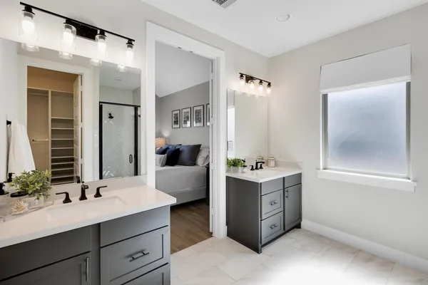 a spacious bathroom with a double vanity sink and mirror