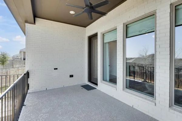 a view of a hallway with a ceiling fan