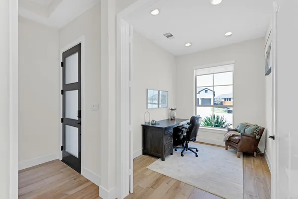 a view of a workspace with furniture and a window