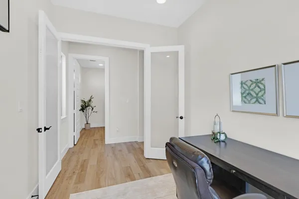 a hallway with a large mirror on a dresser