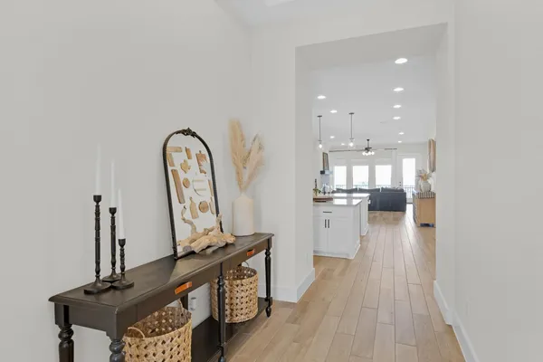 a view of a kitchen with a stove and a wooden floor