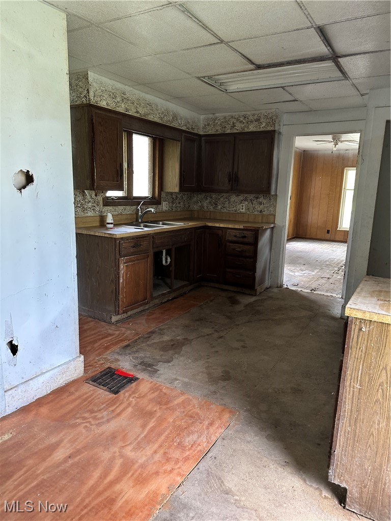 6144 Jefferson Road Ashtabula, OH 44004 - Photo 2 of 30 Kitchen featuring a sink, a paneled ceiling, plenty of natural light, dark brown cabinets, and light countertops