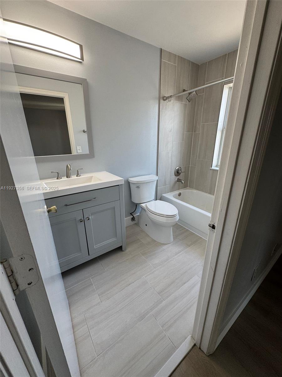 12605 Southwest 54th Court, Unit 12605 Miramar, FL 33027 - Photo 7 of 13 a bathroom with a sink a toilet and shower