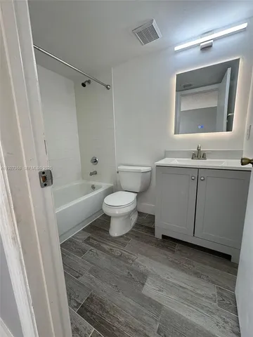 a bathroom with a sink toilet a mirror and shower