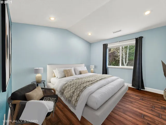 a bedroom with bed couch and window