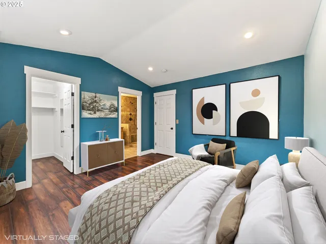 a bedroom with a large bed and a flat tv screen