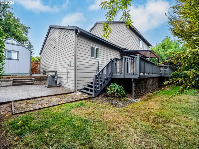 a balcony with wooden floor table and chairs