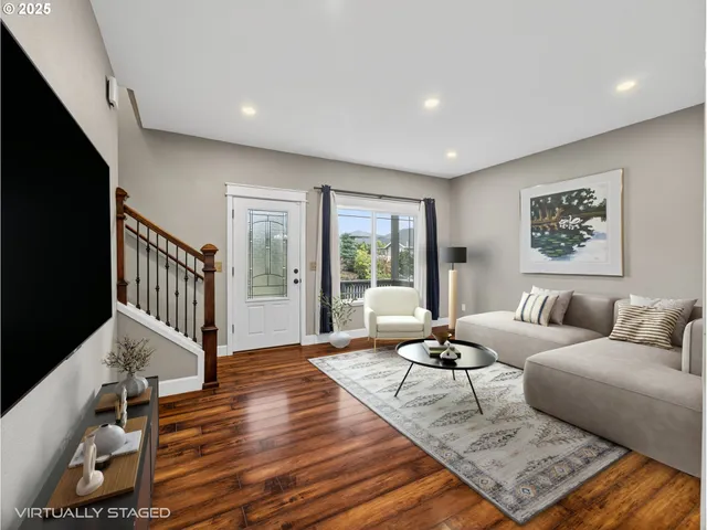 a living room with furniture and a dining table with wooden floor