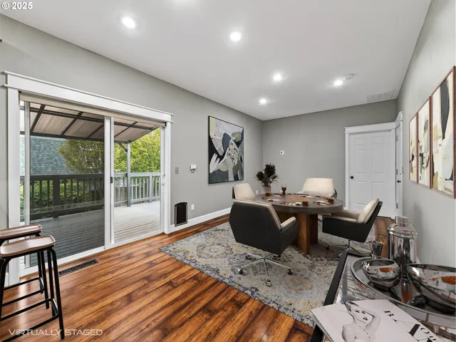 a living room with furniture a flat screen tv and a floor to ceiling window