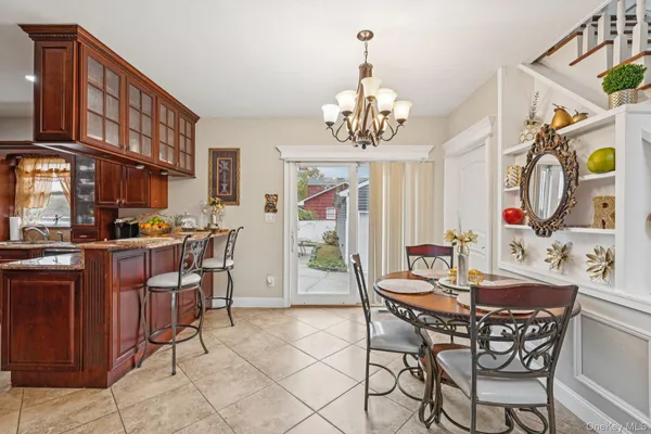 a view of a dining room with furniture and chandelier
