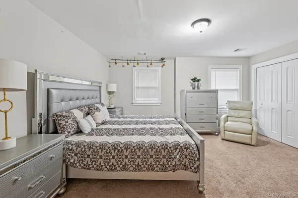 a bedroom with a bed and a dresser