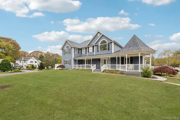a front view of a house with a garden and porch