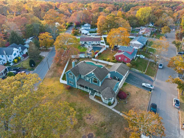 an aerial view of residential house with outdoor space and swimming pool