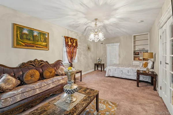 a living room with furniture and a chandelier