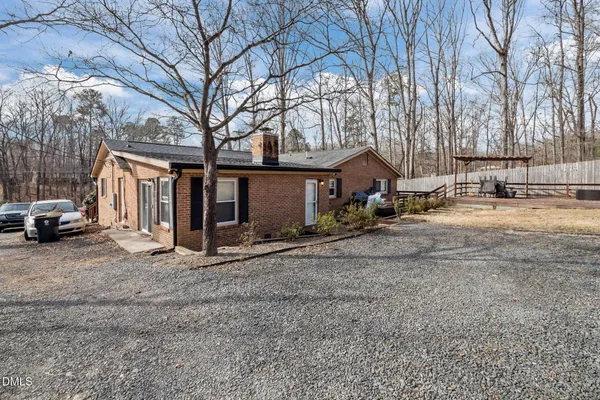 a view of a house with a yard covered in the road