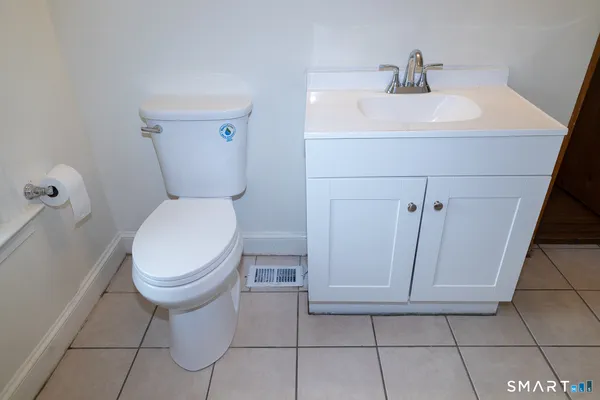 a bathroom with a sink toilet and mirror