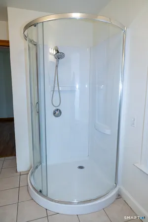 a bathroom with a glass shower door