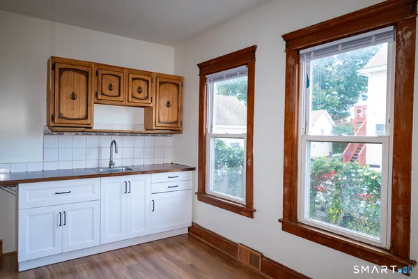 a view of a kitchen with electric board and wooden floor