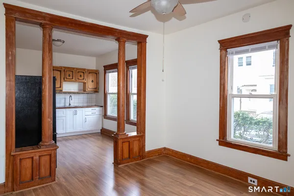 a view of a kitchen with wooden floor and a window
